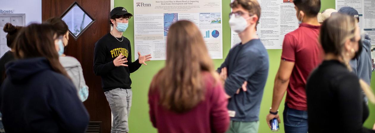 Students present scientific posters to their peers